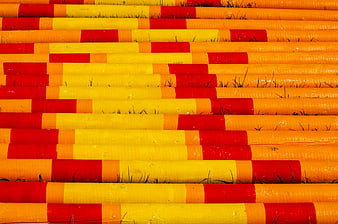 Colorful striped horse jump poles on grass
