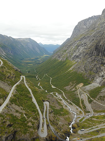Winding Mountain Road Through Green Valley in Norway