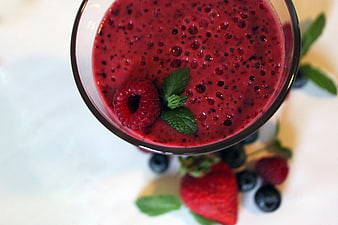Top-Down View of Red Berry Smoothie Garnished with Raspberry and Mint