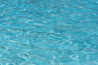 Close-up of rippling blue swimming pool water surface