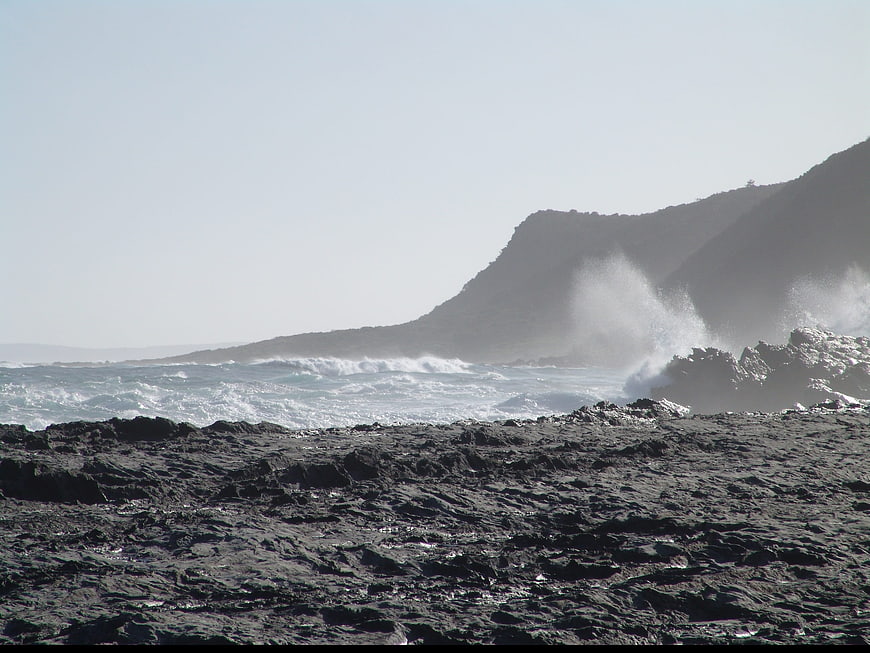 Rough Ocean Waves Crashing Against Rocky Coastal Shoreline