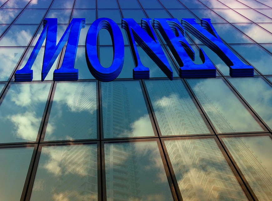 Blue Money Text On Glass Skyscraper Facade With Cloud Reflections
