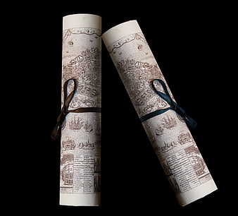 Rolled Vintage Parchment Scrolls with Ribbons on Black Background