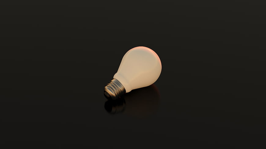 Glowing Light Bulb on Dark Background