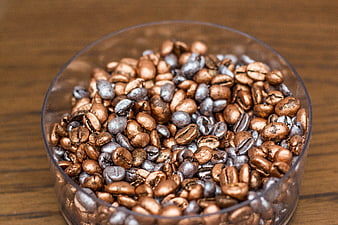 Metallic Gold and Silver Coffee Beans in Glass Bowl