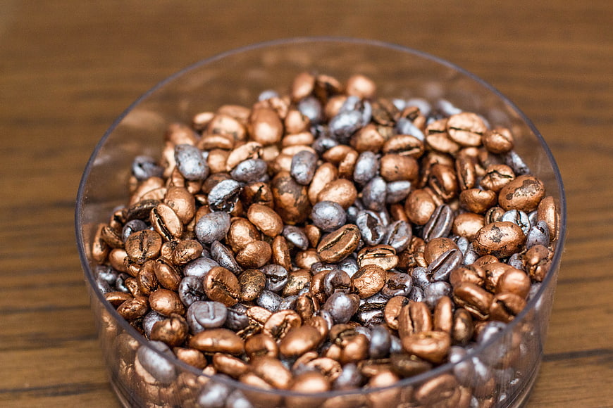 Metallic Gold and Silver Coffee Beans in Glass Bowl