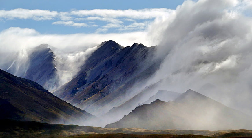 Dramatic Mountain Peaks Shrouded in Mist and Clouds