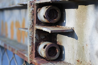 Close-up of rusty metal bolts on industrial steel structure