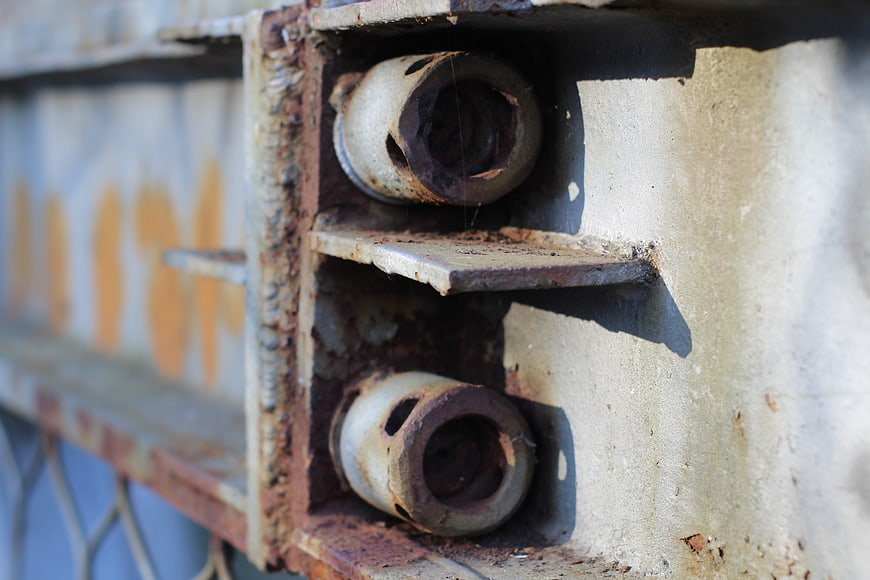 Close-up of rusty metal bolts on industrial steel structure