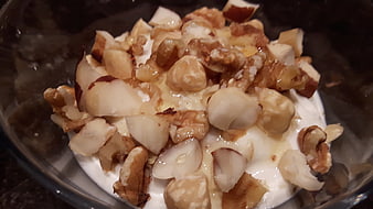 Close-up of quark yogurt topped with hazelnuts and honey