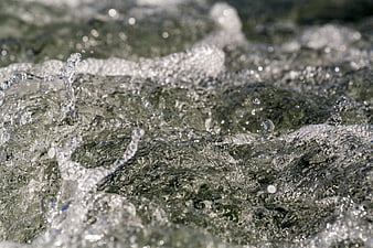 Close-up of splashing clear water with bubbles and ripples