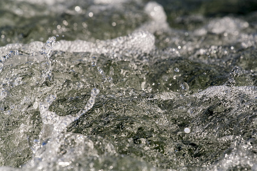 Close-up of splashing clear water with bubbles and ripples