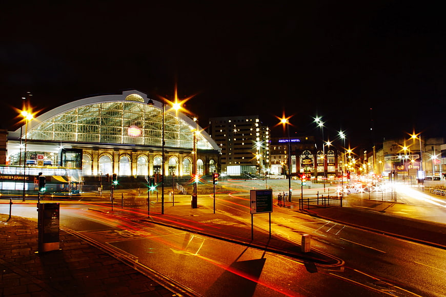 Nighttime long exposure of illuminated train station and city traffic
