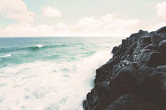 Ocean Waves Crashing Against Rocky Coastline
