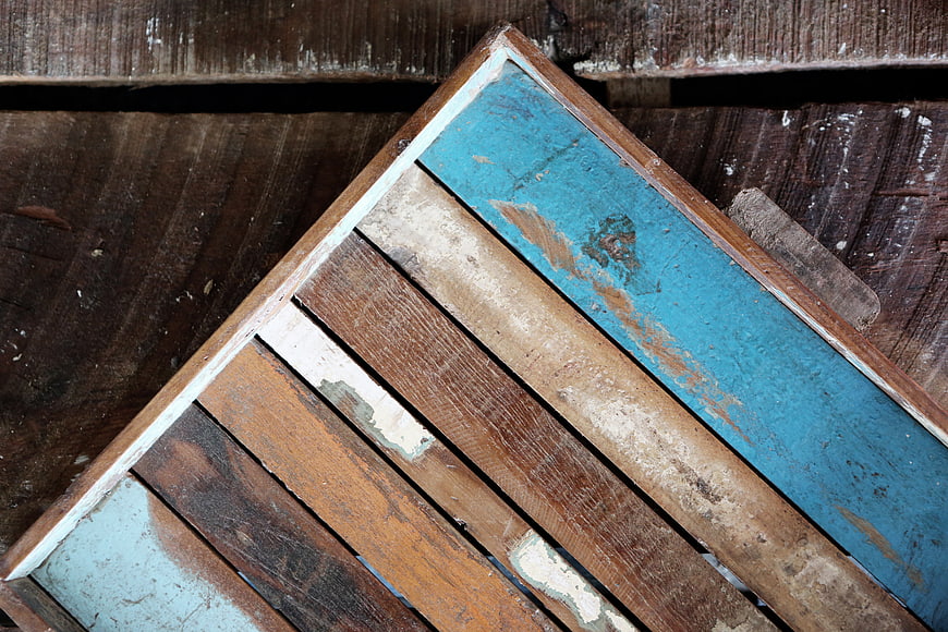 Vintage wooden crate with distressed blue and brown paint texture