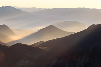 Misty Mountain Landscape at Sunrise with Golden Light