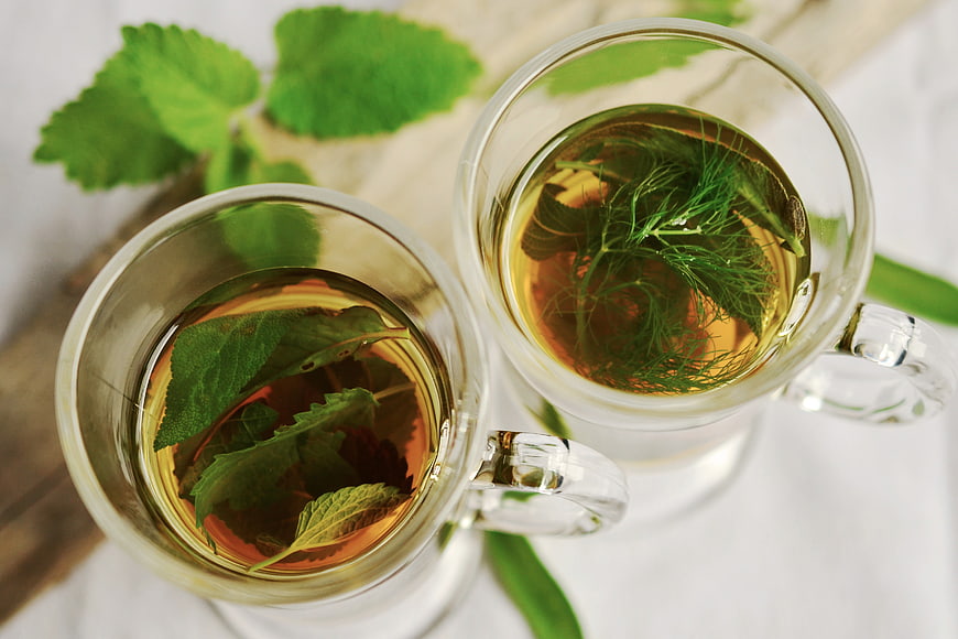 Top View of Herbal Tea with Fresh Mint and Dill Leaves