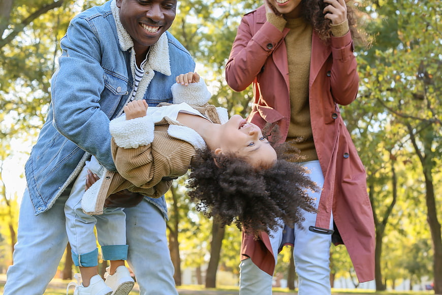 Happy African American Family Playing in Park