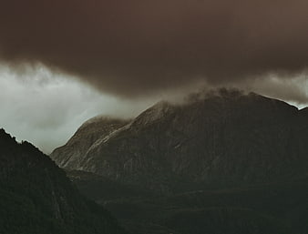 Dramatic dark mountain landscape under stormy clouds