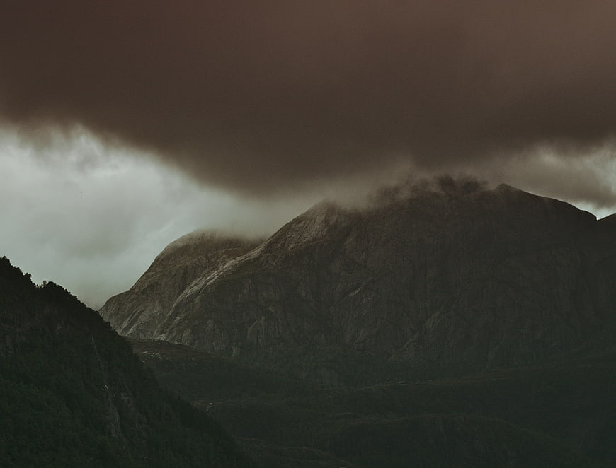 Dramatic dark mountain landscape under stormy clouds