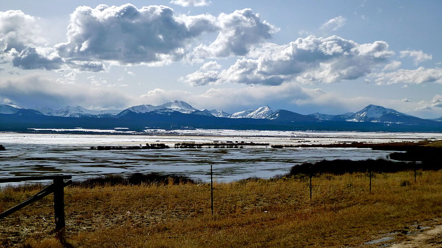 Snowy Montana Mountains Over Frozen Wetland Landscape
