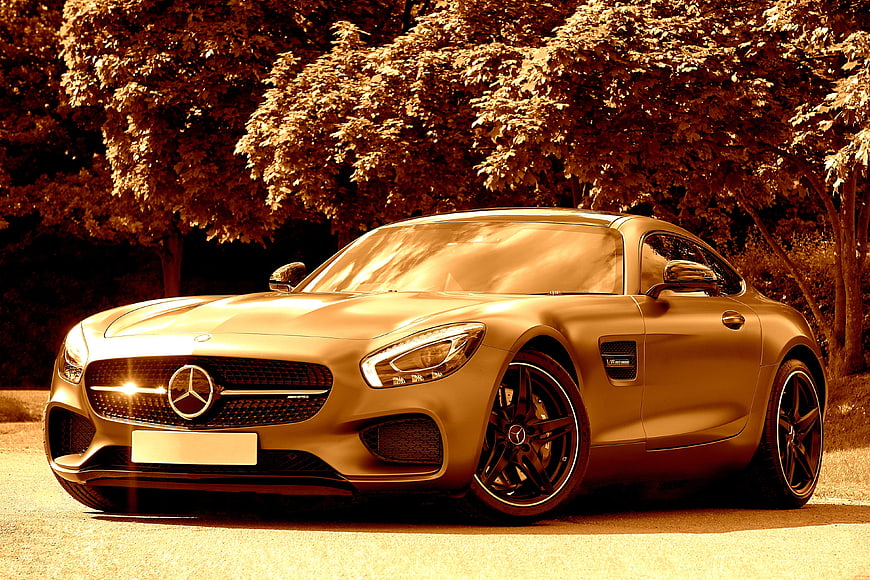 Gold Mercedes AMG GT S Coupe Parked On Tree-Lined Road