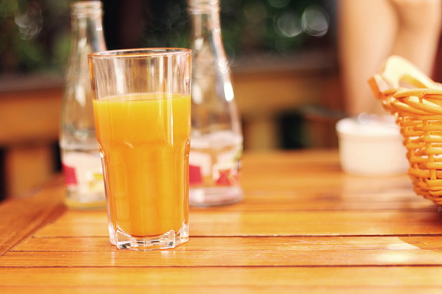 Fresh Orange Juice in Glass on Wooden Table