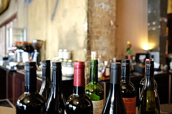 Wine bottles on bar counter with rustic background