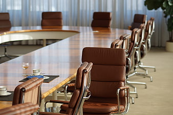 Empty modern conference room with leather chairs and wooden table