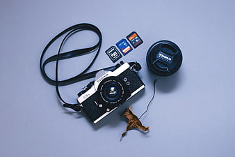 Vintage Cosina Camera Flat Lay with Memory Cards and Lens Cap