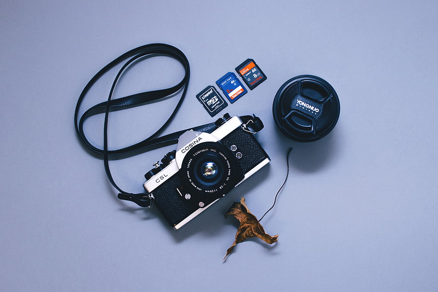 Vintage Cosina Camera Flat Lay with Memory Cards and Lens Cap