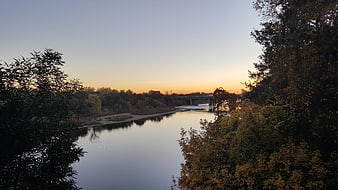 Serene River Landscape at Sunset with Autumn Trees