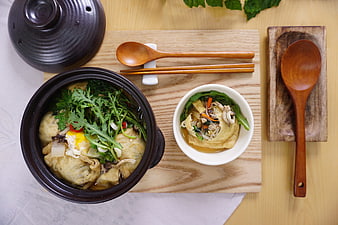 Korean Fish Cake Soup With Fresh Herbs And Wooden Utensils