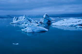 Serene Blue Icebergs Floating in Arctic Waters