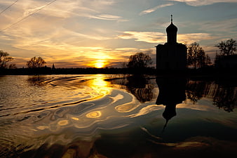 Silhouette of Orthodox Church Reflected in Water at Sunset