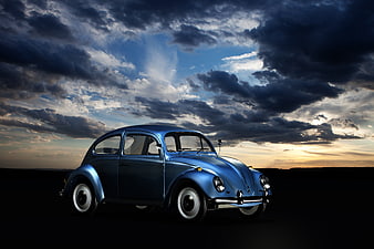 Classic Blue Volkswagen Beetle Under Dramatic Cloudy Sky