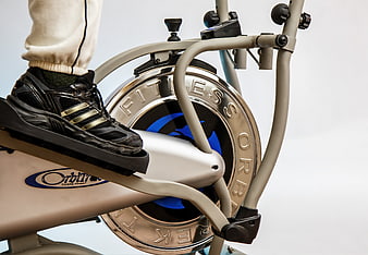 Close-up of black sneaker on elliptical machine pedal