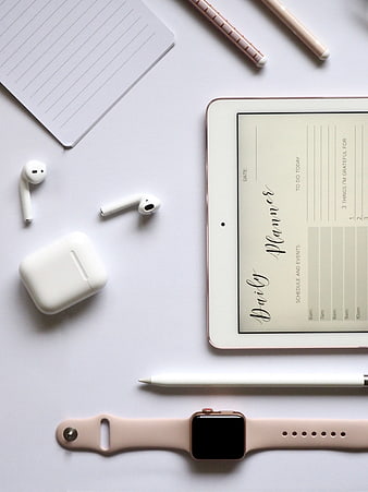 Minimalist Flat Lay of Tablet, Apple Watch, and Airpods on White Desk