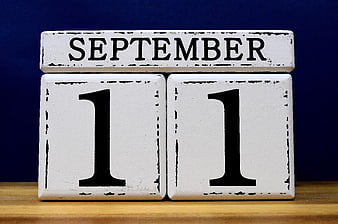 Vintage Wooden Blocks Displaying September 11 Date on Blue Background