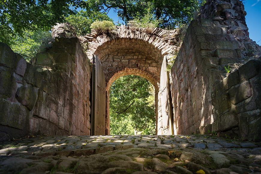 Low angle view of ancient stone castle gate ruins