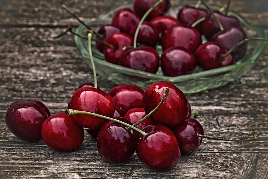 Fresh Ripe Red Cherries on Rustic Wooden Table