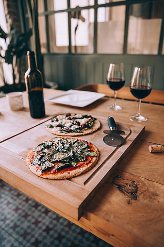 Homemade Pizza and Red Wine on Rustic Wooden Table