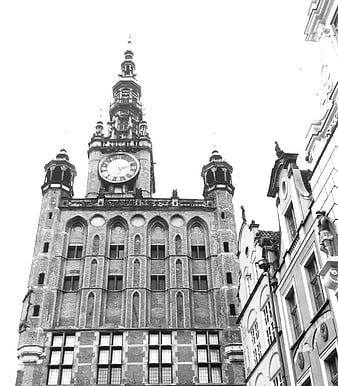 Black and white low angle view of historic clock tower in Gdansk