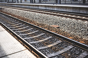 Empty Train Tracks at Station Platform with Gravel