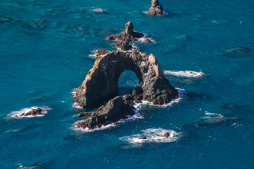 Aerial View of Natural Rock Arch in Turquoise Ocean