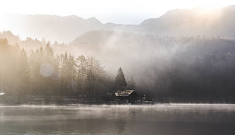 Misty Morning Lake with Cabin and Mountains