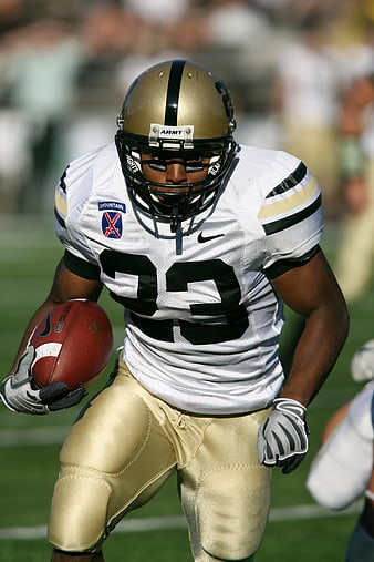 Army football player running with ball on field