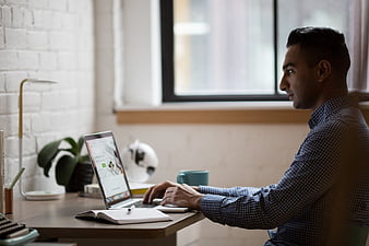 Man working on laptop in modern home office