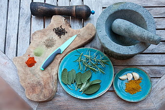 Top View of Spices, Herbs, and Kitchen Tools on Wooden Table
