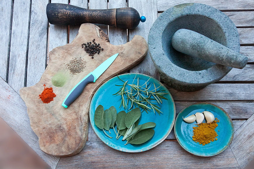Top View of Spices, Herbs, and Kitchen Tools on Wooden Table